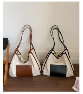 Detailed comparison of beige canvas tote bags with brown and black leather trim accents