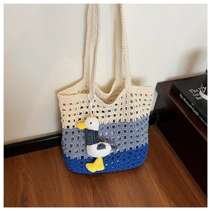 Close-up of the tricolor knit texture on the beach tote bag with a cute duck charm
