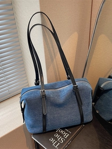 Borsa da viaggio in denim blu con tracolle in pelle regolabili e dettagli argento