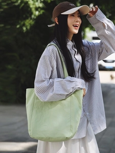 Minimalist light green large tote bag for women showing a stylish crossbody shoulder style