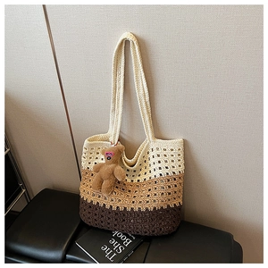 Close-up of three-tone crochet tote bag with hollow patterns and a cute bear charm