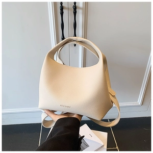 Detailed close-up of beige lychee-patterned leather bucket bag with brand logo