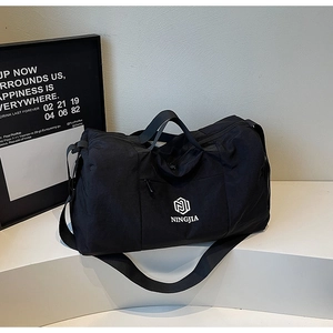 Close-up of black multi-functional travel bag with dry-wet separation on white stage