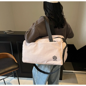 Detailed back view of a pink travel bag with shoulder strap and large capacity