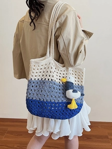 Handwoven oversized beach tote bag in blue gradient with a cute seagull plush pendant