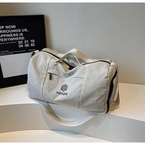 Close-up of beige waterproof travel bag with NINGJIA logo and sturdy black zipper detail