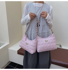 Detail showing pink quilted leather texture and golden metal lock on classic bucket bags