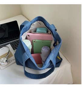 Detailed top view of a large denim tote bag showing interior storage capacity and lining