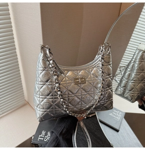 Close-up of silver quilted texture and metallic chain strap on the bucket bag