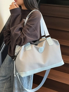 Large capacity light blue travel bag with carry handle and adjustable shoulder strap