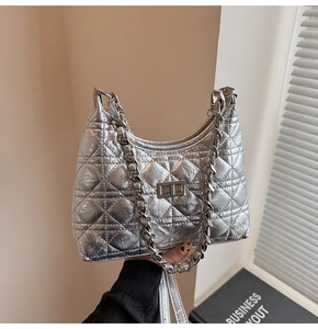 Detailed view of silver quilted hobo bag with metallic finish and metal chain handle