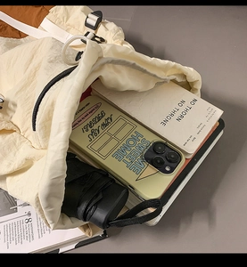 Detail of the drawstring closure and interior capacity for phone, notebook and umbrella