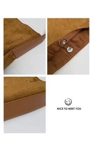 Macro shot of brown suede texture, stitching detail and magnetic closure on tote bag