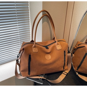 Detail of vintage brown travel tote with front vertical zippers and detachable strap