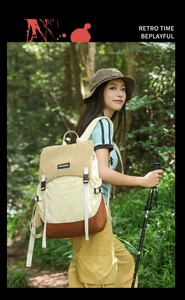 Outdoor backpack in khaki and beige colorblock design worn by a model in nature