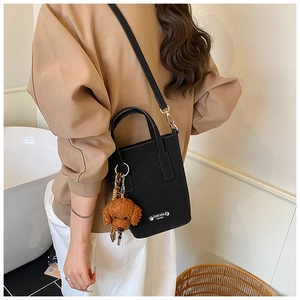 Black PU crossbody bag with plush teddy bear charm and silver logo detail