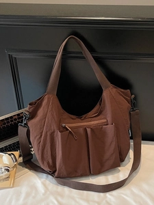 Brown large capacity nylon tote bag with utility pockets and adjustable shoulder strap