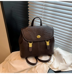 Detailed view of dark brown retro backpack featuring vintage oil wax leather and gold hardware