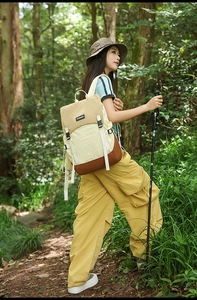Outdoor hiking backpack with color-block design shown in a lush forest environment