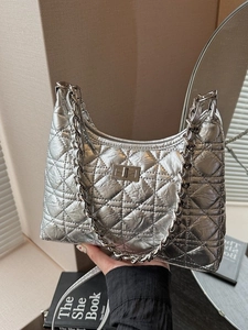 Silver quilted hobo shoulder bag with chain handle and metallic finish texture