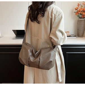 Deep taupe soft leather hobo bag featuring natural drapes and slouchy minimalist design