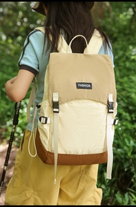 Close-up of tricolor waterproof backpack featuring buckle flap and side storage pocket