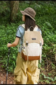 Detail view of water-resistant patchwork backpack with buckles in forest hiking scene