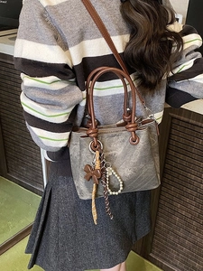 Retro taupe bucket bag with bow charm and pearl chain accessory for women