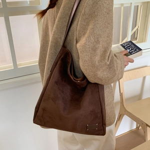 Detail of dark brown matte suede tote bag showing large capacity and soft texture