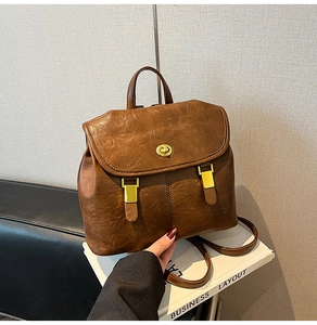 Detailed view of vintage brown PU leather backpack with gold metal twist lock buckle