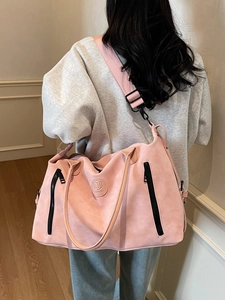 Pink large capacity travel bag for fitness or weekend trips shown with shoulder strap