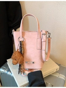Pink crossbody phone bag in faux suede with teddy charm and London metal logo plate