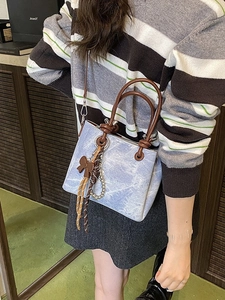 Retro marble pattern bucket bag in light blue with brown handles and elegant bow detail