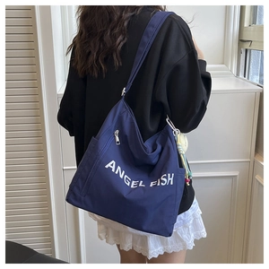 Detail view of large capacity dark blue canvas shoulder bag with Angel Fish print