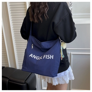 Detail of deep blue canvas shoulder bag with white Angel Fish print on thick fabric
