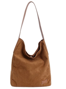 Brown suede minimalist tote bag with smooth leather straps and decorative corner stitching