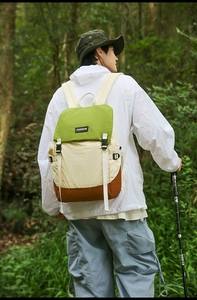 Hiking backpack detail showing splash-proof nylon fabric and buckle closure in forest setting