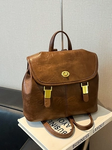 Vintage brown leather backpack with gold hardware and top handle for women