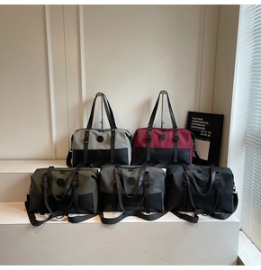 Macro detail of multi-color travel bags with fabric and faux leather patchwork design