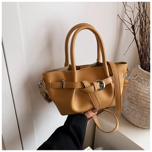 Détail du sac seau en cuir jaune avec texture de litchi et boucle en métal argenté