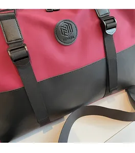 Detail of water-resistant fabric and premium leather stitching on pink travel bag