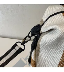 Detailed close-up of premium gunmetal hardware on a striped canvas yoga tote bag