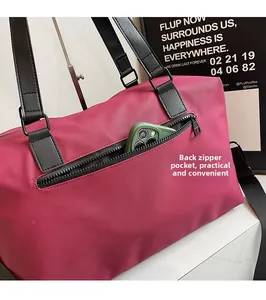 Detail showing the practical back zipper pocket of the large fuchsia travel duffel bag