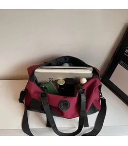 Detail shot of the spacious red and black travel bag interior holding various items