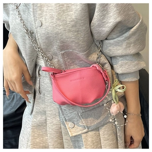 Détail du sac seau en cuir grainé rose avec chaîne argentée et breloque tulipe