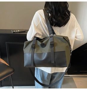 Detail of army green and black large travel bag with leather accents and round logo