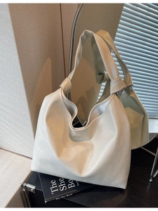 Chic beige leather tote bag with knotted shoulder strap for daily commuting