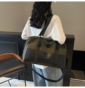 Olive green travel bag shown with adjustable shoulder strap on female model in modern room