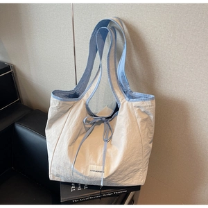 Detailed macro view of the cream and blue canvas tote bag with Love Morning fabric label