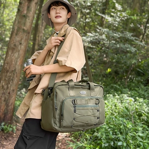 Close-up of army green high-capacity travel bag featuring multiple storage pockets